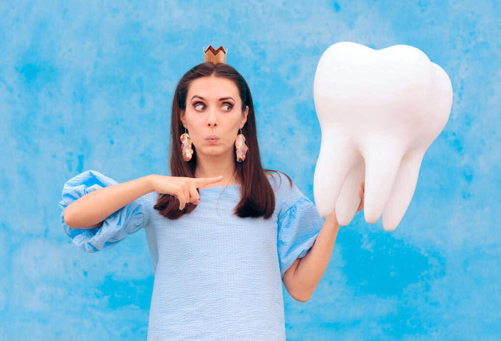 Woman in Tooth Fairy Costume Holding Big Molar