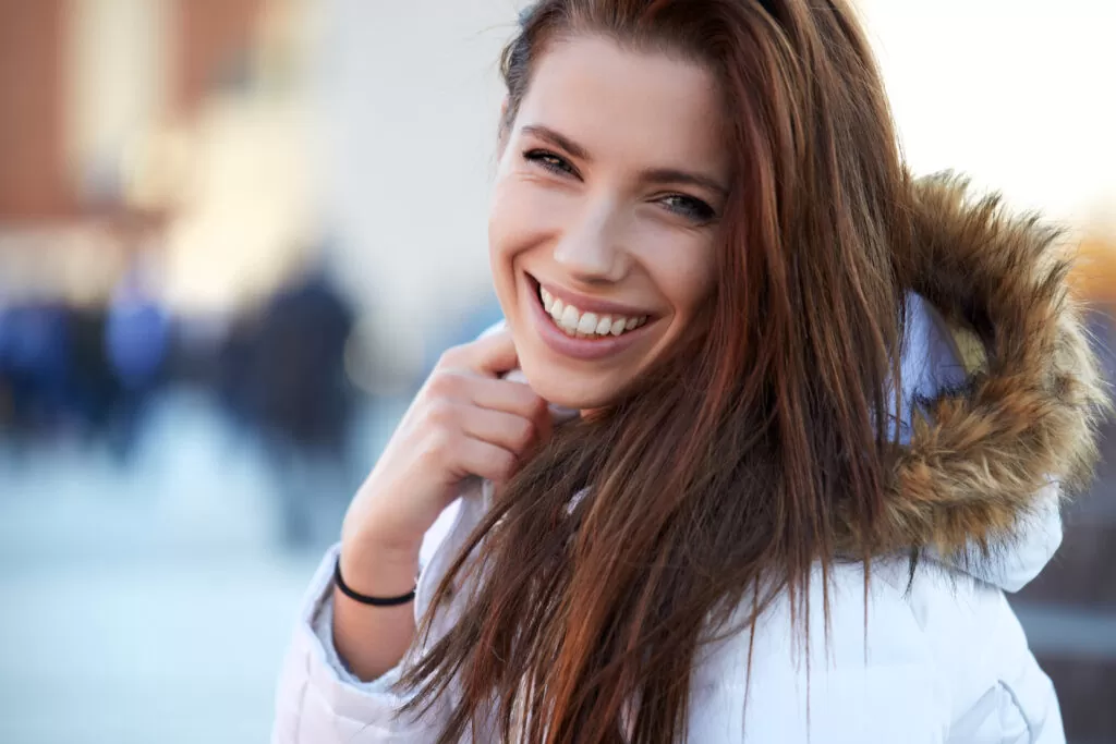 young woman smiling outside in the cold