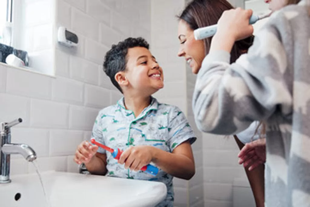 Mother and son smiling after cleaning their teeth in El Paso.