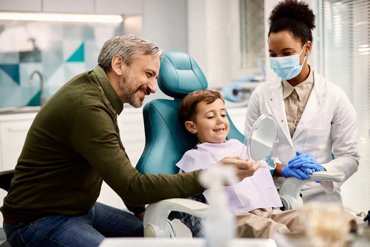 A child and their parent with a family dentist in El Paso.